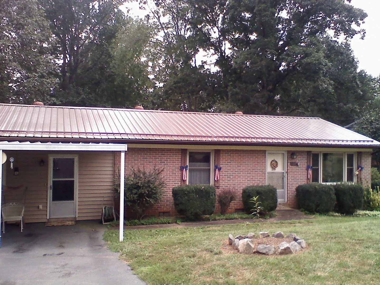 Bronze metal roof and carport on a brick ranch home — Roof Repair work by our crew in Rock Stream